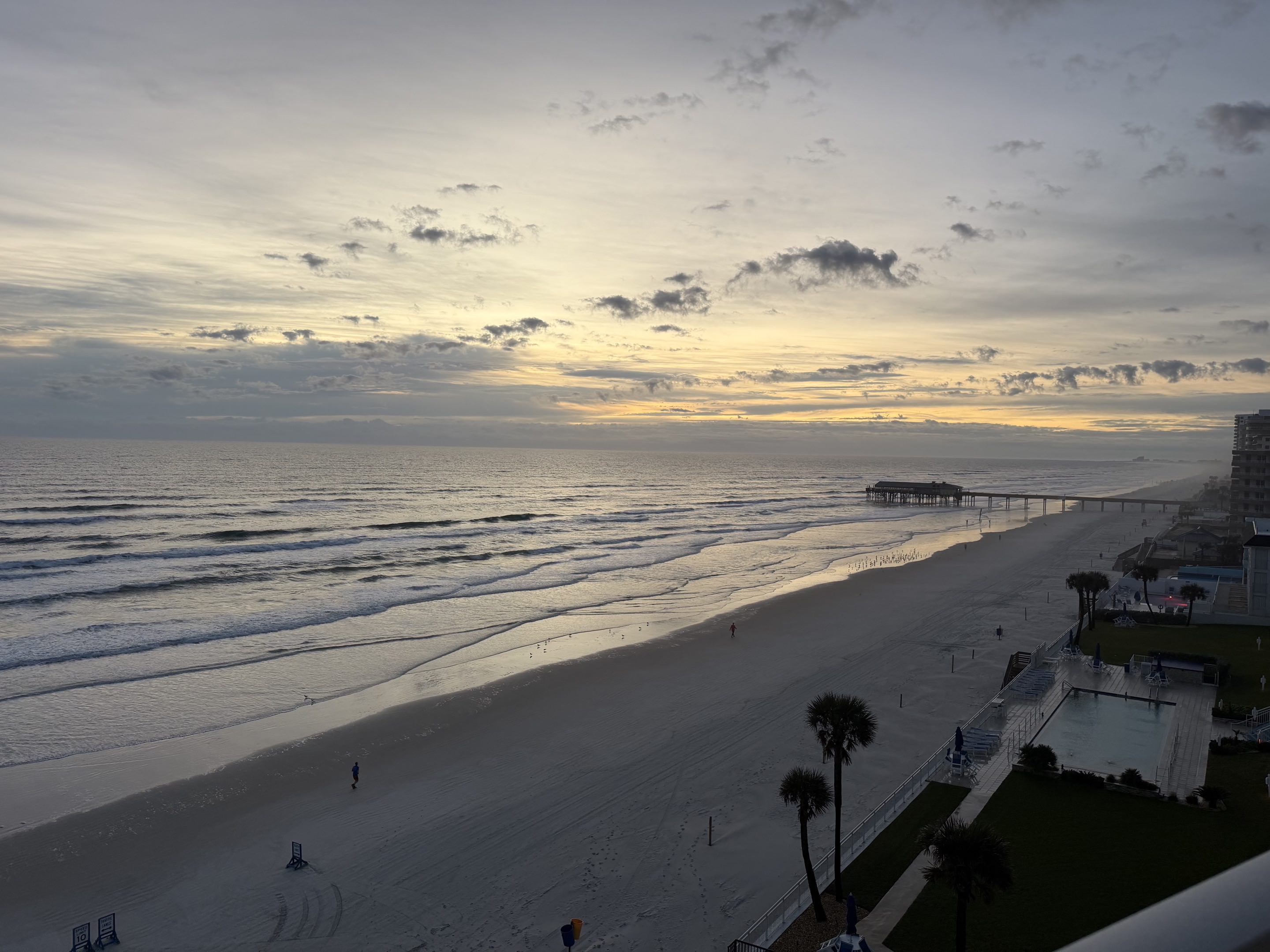 A beach at dawn viewed from a high balcony